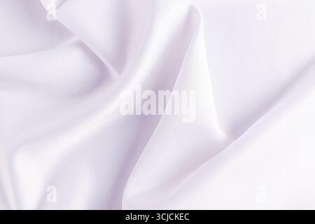 A serene and elegant satin fabric background with smooth, flowing drapes in soft white tones. Ideal for adding a touch of luxury to any design or even Stock Photo
