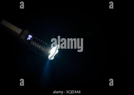 High strong power led flashlight on a black background, close up. Tactical emergency spotlight with telescopic zoom, built-in battery, usb rechargeabl Stock Photo