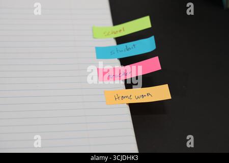 sticky notes stuck to a school notebook written on them student teacher school homework Stock Photo