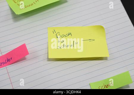 sticky notes stuck to a school notebook written on them student teacher school homework Stock Photo