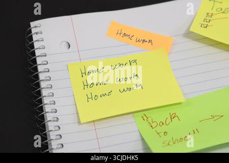 sticky notes stuck to a school notebook written on them student teacher school homework Stock Photo