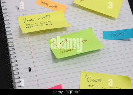 sticky notes stuck to a school notebook written on them student teacher school homework Stock Photo