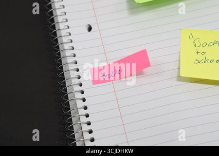 sticky notes stuck to a school notebook written on them student teacher school homework Stock Photo
