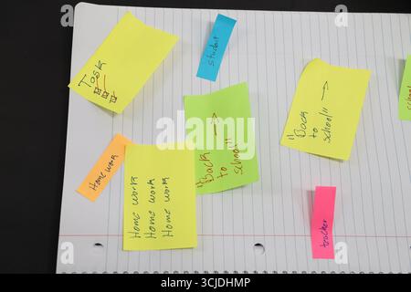 sticky notes stuck to a school notebook written on them student teacher school homework Stock Photo
