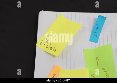 sticky notes stuck to a school notebook written on them student teacher school homework Stock Photo