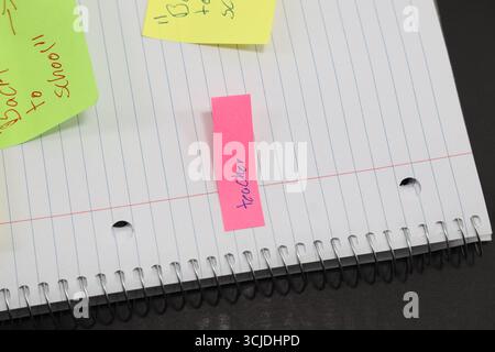 sticky notes stuck to a school notebook written on them student teacher school homework Stock Photo