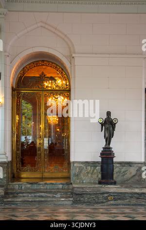 An Art Nouveau style woman bronze statue holding a clock and a barometer inside Casa Loma gothic revival castle style mansion in Toronto, Ontario, Can Stock Photo