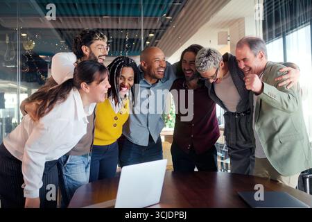 Diverse team huddle in modern office Stock Photo