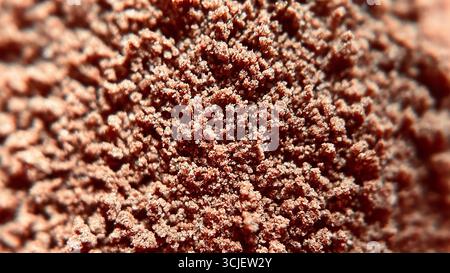 A close-up view of rich brown chocolate powder, showing its fine texture, soft grains, and cocoa-rich surface, often used in desserts, baking, drinks, Stock Photo