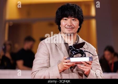 Akio Fujimoto poses with the Orizzonti Special Jury Prize for