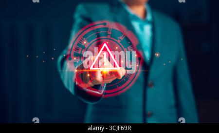 Businessman pressing digital warning alert icon on virtual screen, concept of cybersecurity risk, data protection, internet safety, system failure and Stock Photo
