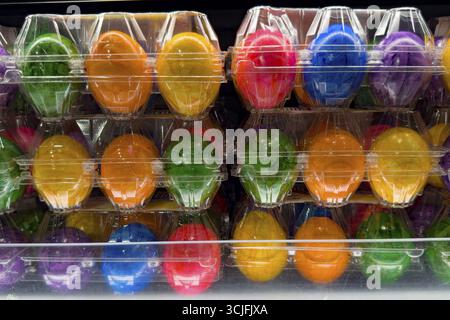 Colourful dyed hard-boiled eggs Easter eggs in plastic blister packs for year-round retail sale, Germany Stock Photo