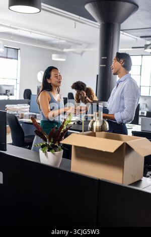 Colleagues discussing project in modern office, sharing ideas and collaborating Stock Photo