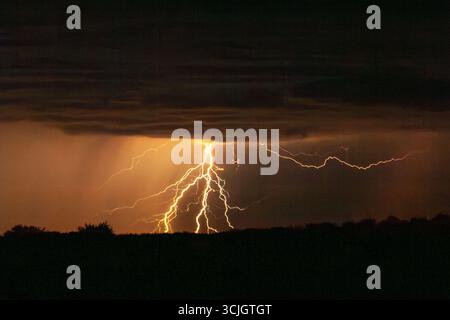 Powerful lighting strikes, thunder and storm in Kgalagadi National Park in South Africa Stock Photo