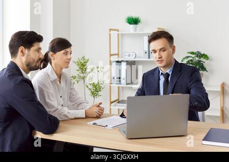 Business people consulting with a young lawyer, close-up Stock Photo