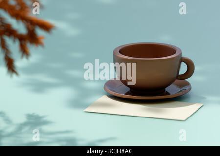 A brown coffee cup on a saucer sits on a blue table beside a blank paper under soft light. 3d rendering Stock Photo