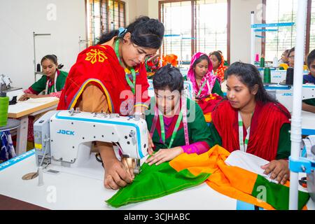 Bangladesh – May 21, 2019: A teacher teaches her students to sew clothes using a sewing machine in the Chuadanga district. Stock Photo
