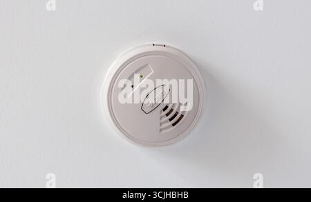 A domestic Smoke Detector on the ceiling Stock Photo