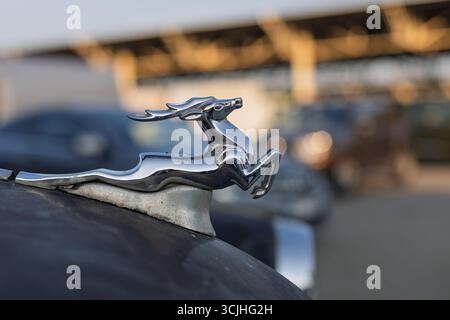 Wroclaw, Poland - August 28 2025: Soviet GAZ Volga deer mascot with blurred urban background Stock Photo
