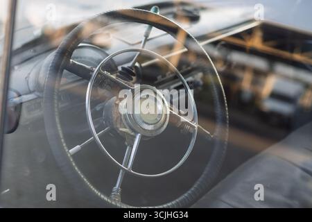 Wroclaw, Poland - August 28 2025: Steering wheel with deer emblem inside vintage GAZ Volga Stock Photo