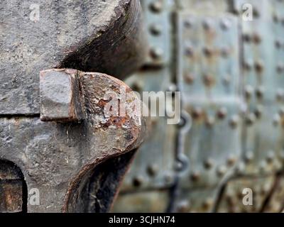 Large size bolts and nuts in iron and steel factories, old vintage rusty metal door Stock Photo