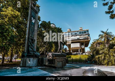 Buenos Aires, Argentina – December 22, 2022: Monumento a Nicolás Avellaneda with the Brutalist Biblioteca Nacional Mariano Moreno in the background Stock Photo