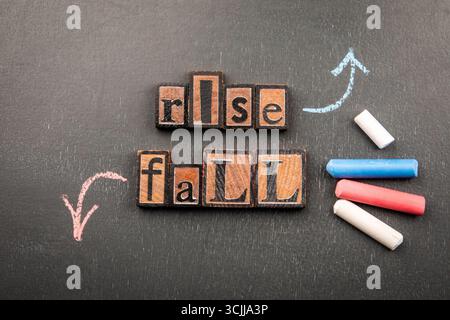 Conceptual image of chalk-drawn arrows representing Rise and Fall drawn step-by-step on a blackboard. Stock Photo
