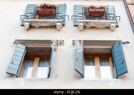 The front of the house with green shutters and flower boxes on the windows Stock Photo