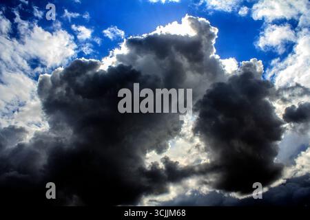 A dramatic sky showcasing a striking contrast between dark storm clouds and bright, clearing skies in Sydney, NSW, Australia. (Photo by Tara Chand Mal Stock Photo