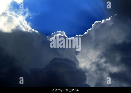 A dramatic sky showcasing a striking contrast between dark storm clouds and bright, clearing skies in Sydney, NSW, Australia. (Photo by Tara Chand Mal Stock Photo