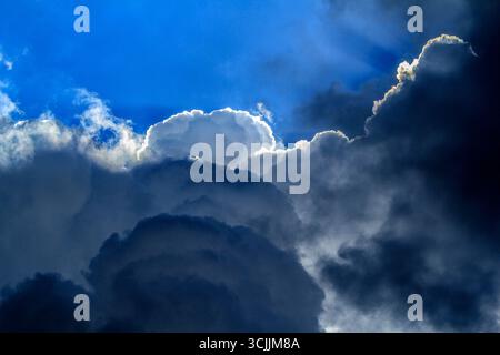 A dramatic sky showcasing a striking contrast between dark storm clouds and bright, clearing skies in Sydney, NSW, Australia. (Photo by Tara Chand Mal Stock Photo