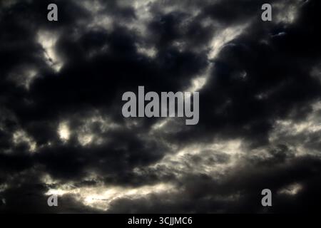 A dramatic sky showcasing a striking contrast between dark storm clouds and bright, clearing skies in Sydney, NSW, Australia. (Photo by Tara Chand Mal Stock Photo