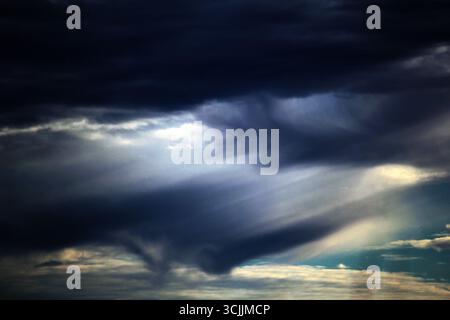 A dramatic sky showcasing a striking contrast between dark storm clouds and bright, clearing skies in Sydney, NSW, Australia. (Photo by Tara Chand Mal Stock Photo
