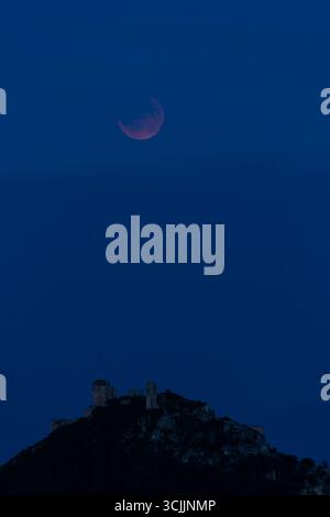 Partial lunar eclipse over the ruins of Staatz Castle in Lower Austria, Austria Stock Photo