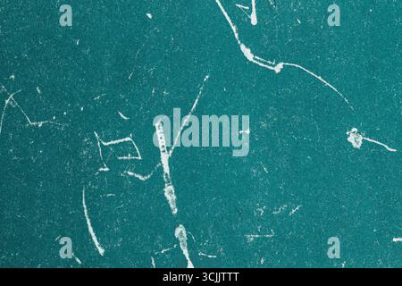 Grungy teal paper texture with white fiber and scratch marks scattered across surface. Concept of distressed detail, vintage imperfection, textured Stock Photo