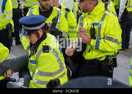 A young woman is carried away by police and arrested for holding a sign in support of Palestine Action. London September 6th 2025. Stock Photo