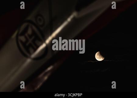 Lisbon, Portugal. 07th Sep, 2025. A red full moon, also known as a blood moon, is seen during a lunar eclipse over an aircraft placed as a monument at Air Base No. 1 in Sintra. (Photo by Henrique Casinhas/SOPA Images/Sipa USA) Credit: Sipa USA/Ģ����ý Live News Stock Photo
