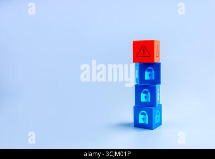Stacked security blocks with padlock icons and red warning cube on top. Concept of cybersecurity, data protection, scam alert, hacker, system breach, Stock Photo
