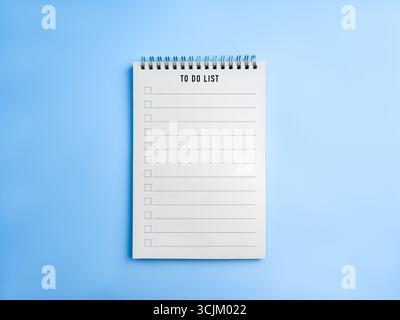 To do list and checklist template on spiral notebook with blue background, symbolizing productivity, task management, planning, time management, and g Stock Photo