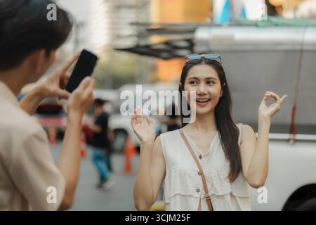 lovely couple take a photo when they are at famous travel destination, the young couple is looking good together, walking and smiling on vacation with Stock Photo