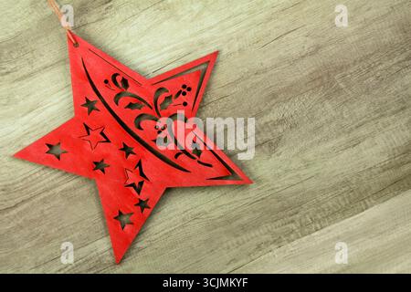 Red wooden Christmas Star on wooden background Stock Photo