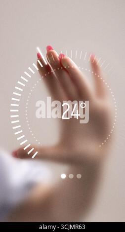 Creative collage. Hand with pink nails rotating futuristic digital dial interface showing 24 degrees Stock Photo