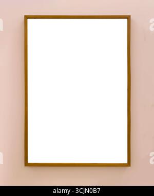 Wooden picture frame hanging on a wall with empty white space inside. Minimalist vertical frame mockup for artwork, painting, photograph, or poster pr Stock Photo