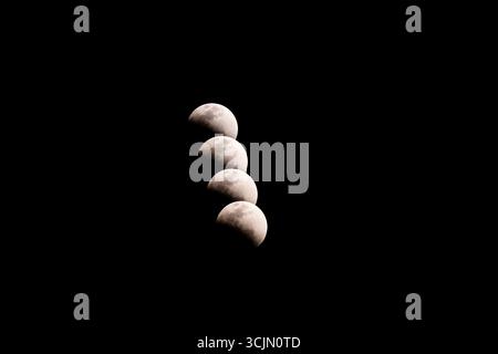 Lunar eclipse composite sequence over night sky, Tete, Mozambique Stock Photo
