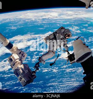 ASTRONAUT WOLF, DAVID-A. STS-112 MISSION SPECIALIST, ANCHORED TO A FOOT ...