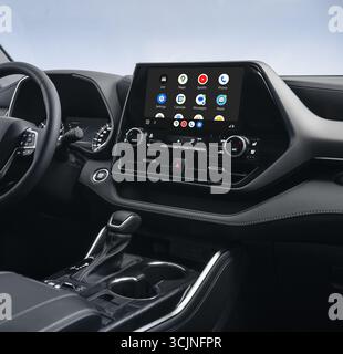 Android auto main screen menu in modern car. Close-up shot of infotainment system in dark car interior. Stock Photo