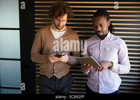 Two happy busy professional business men executive business team working together Stock Photo