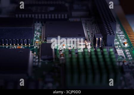Detailed examination of a circuit board highlighting microchips and connections essential for ai and crypto innovations. Stock Photo