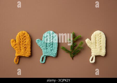 Mini Mittens Handknitted. Christmas Tree Decorations. Minimal winter background. Flat lay. Stock Photo