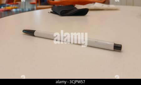 A ballpoint pen on a white table Stock Photo